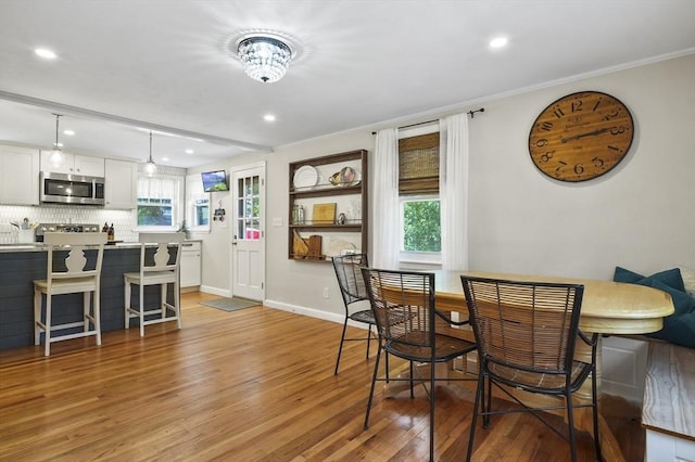 101 Eastern Ave, Woburn, MA 01801 - dining space featuring light wood-style floors, recessed lighting, and crown molding