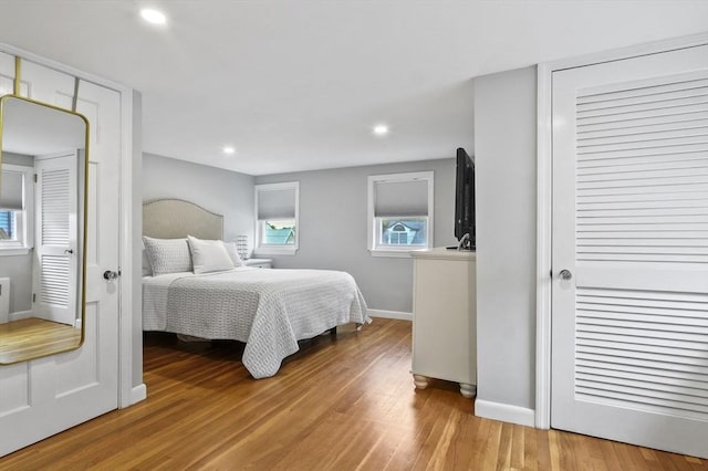 101 Eastern Ave, Woburn, MA 01801 - bedroom with wood finished floors, multiple windows, and recessed lighting