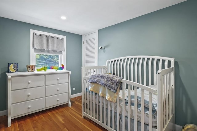 101 Eastern Ave, Woburn, MA 01801 - bedroom with wood finished floors, a nursery area, and recessed lighting
