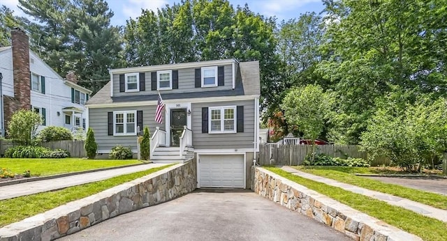 101 Eastern Ave, Woburn, MA 01801 - dutch colonial featuring asphalt driveway, an attached garage, and a shingled roof
