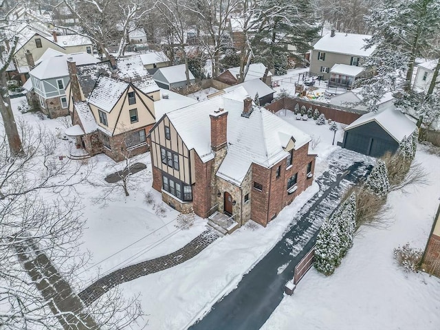 snowy aerial view with a residential view