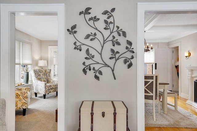 hallway featuring carpet and a chandelier