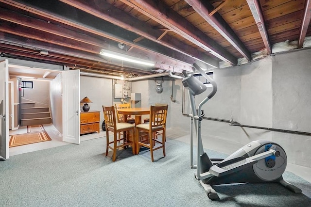 workout area featuring carpet floors, wooden ceiling, and electric panel