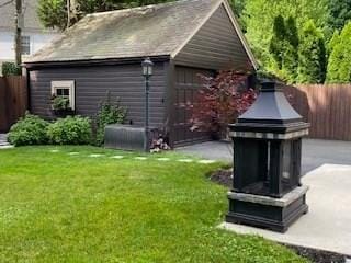 exterior space featuring an outbuilding and a fenced backyard