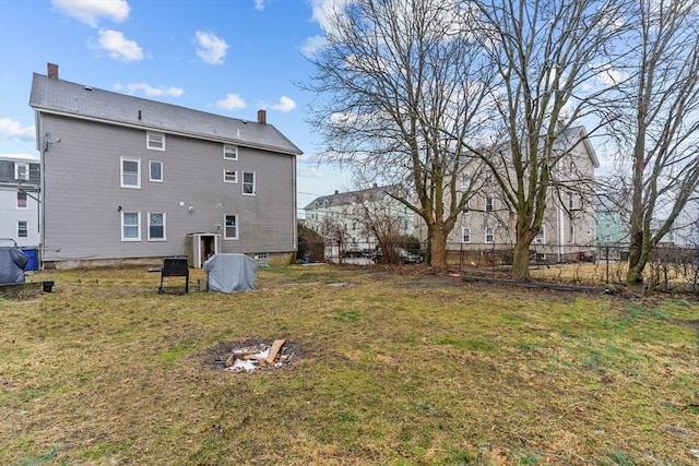 rear view of property featuring a lawn