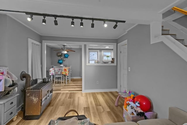 recreation room featuring crown molding and light hardwood / wood-style flooring