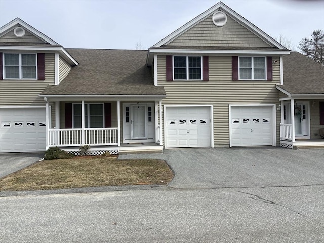 view of front of house featuring a porch, a garage, driveway, and a shingled roof