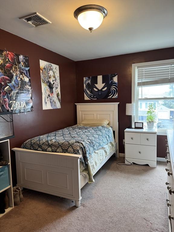 carpeted bedroom with visible vents
