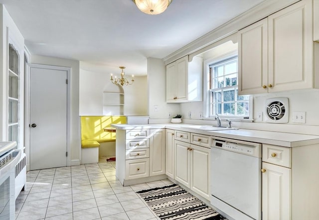 kitchen featuring a peninsula, a sink, light countertops, dishwasher, and a chandelier