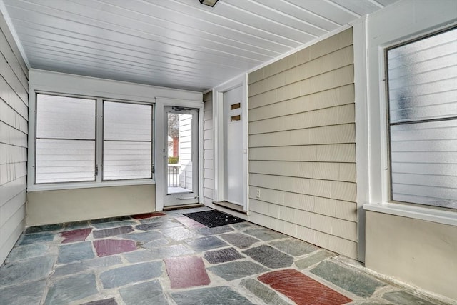 unfurnished sunroom with wooden ceiling