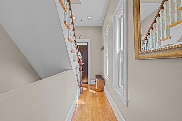 hall featuring stairs, recessed lighting, wood finished floors, and baseboards