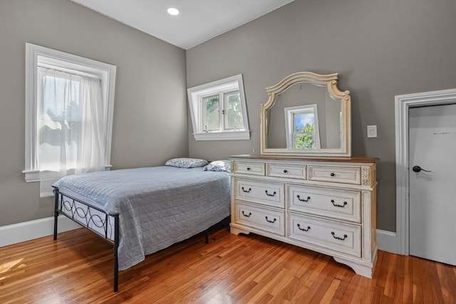 bedroom with baseboards and light wood finished floors