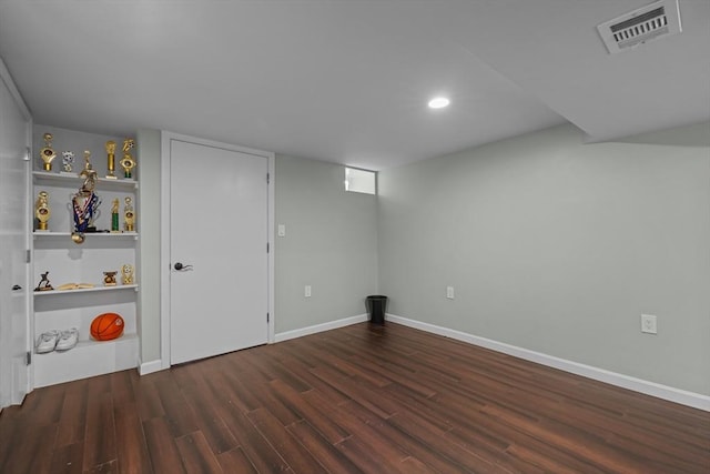 finished below grade area with recessed lighting, visible vents, baseboards, and wood finished floors