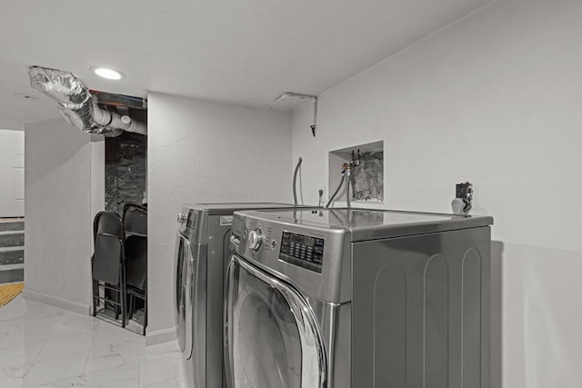 laundry area featuring laundry area, washing machine and dryer, marble finish floor, and baseboards