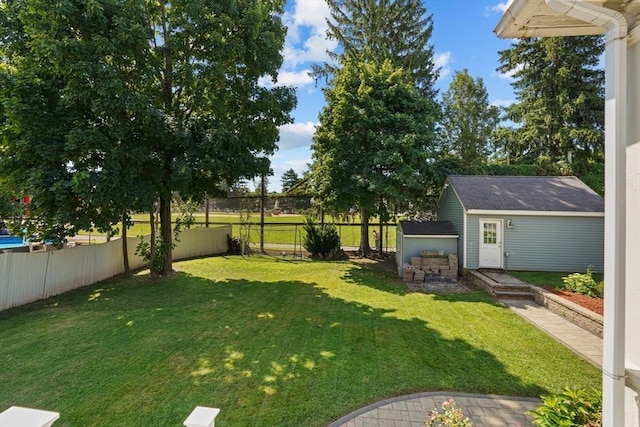 view of yard featuring an outbuilding and a fenced backyard