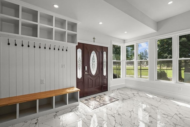 mudroom featuring recessed lighting, marble finish floor, and baseboards