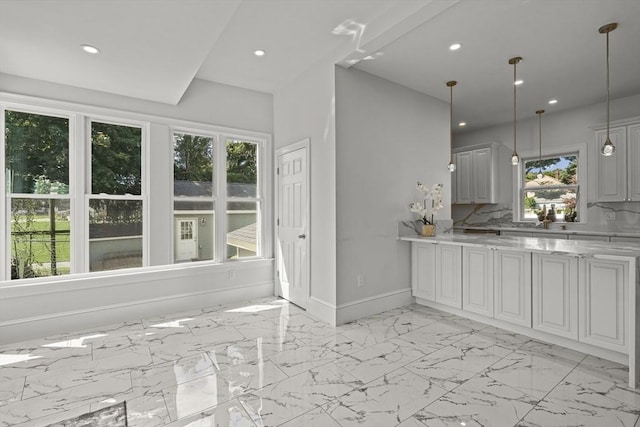 kitchen with marble finish floor, pendant lighting, recessed lighting, baseboards, and light stone countertops