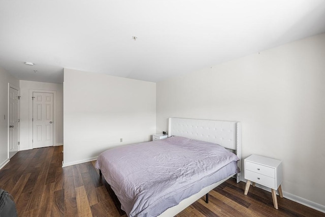 bedroom featuring wood finished floors and baseboards
