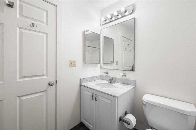 bathroom featuring toilet and vanity