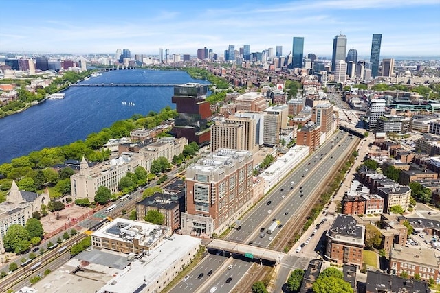 bird's eye view of a view of skyline, a highway, a large body of water, and a notable bridge