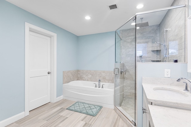 bathroom with plus walk in shower, vanity, and tile flooring