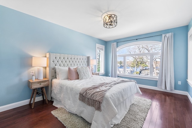 bedroom with dark wood-type flooring