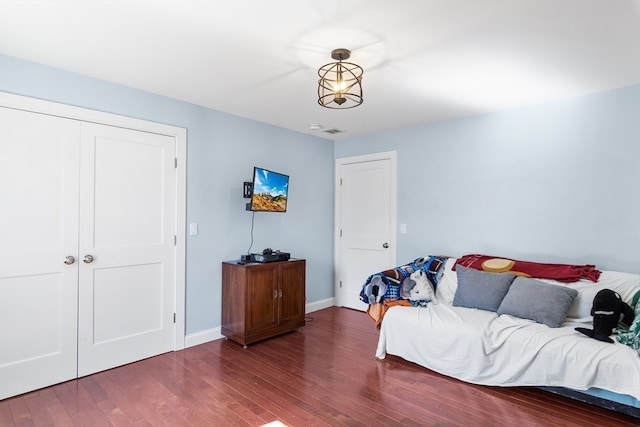 bedroom featuring wood-type flooring and a closet