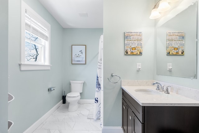 bathroom featuring tile floors, vanity, and toilet