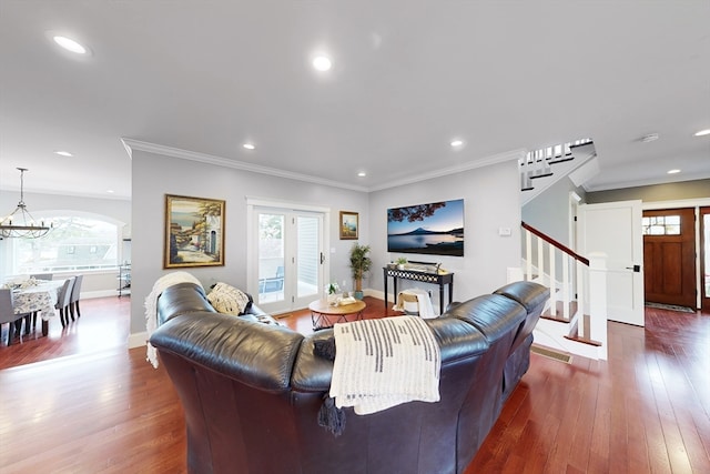 living room featuring ornamental molding, a chandelier, and dark hardwood / wood-style floors