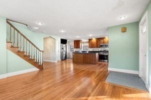 kitchen with a kitchen island, stainless steel appliances, and hardwood / wood-style flooring