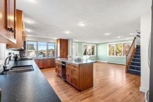 kitchen featuring dishwasher, a center island, light wood-type flooring, and sink