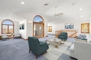 living room with ceiling fan and vaulted ceiling