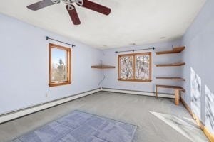 interior space featuring baseboard heating and ceiling fan