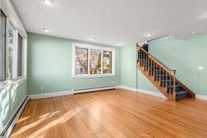 empty room with a baseboard radiator and wood-type flooring