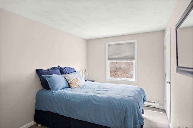 bedroom with a baseboard heating unit, baseboards, and carpet flooring