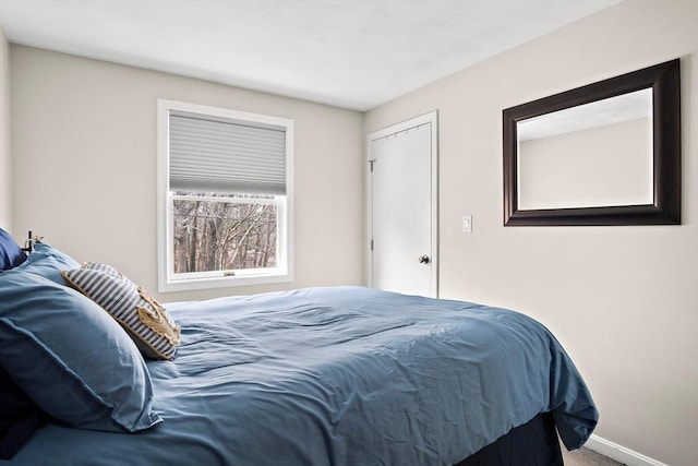 carpeted bedroom with baseboards