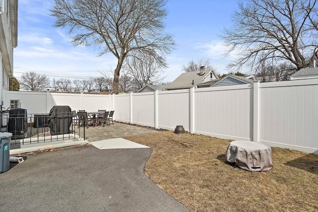 view of yard with outdoor dining space, a patio, central air condition unit, and a fenced backyard