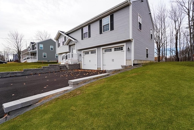 view of front of home featuring a garage and a front lawn