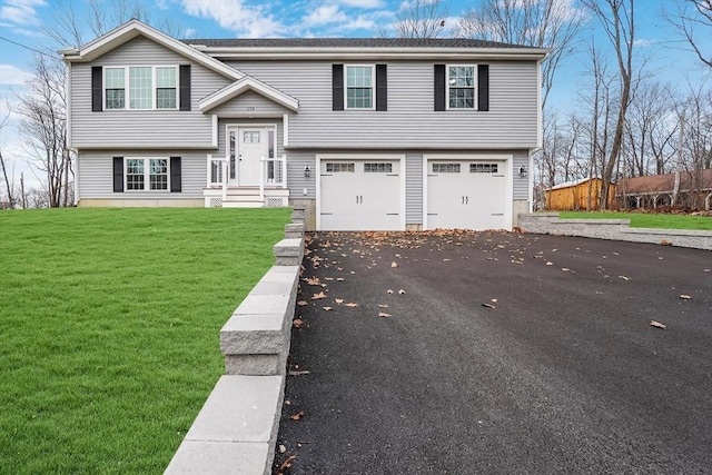 view of front facade with a garage and a front lawn