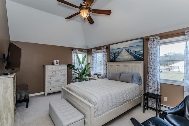 bedroom with light carpet, vaulted ceiling, baseboards, a ceiling fan, and a baseboard radiator