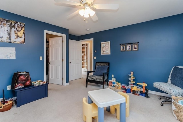 playroom featuring carpet flooring, a ceiling fan, and baseboards