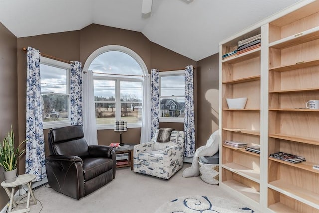 sitting room featuring carpet floors and lofted ceiling
