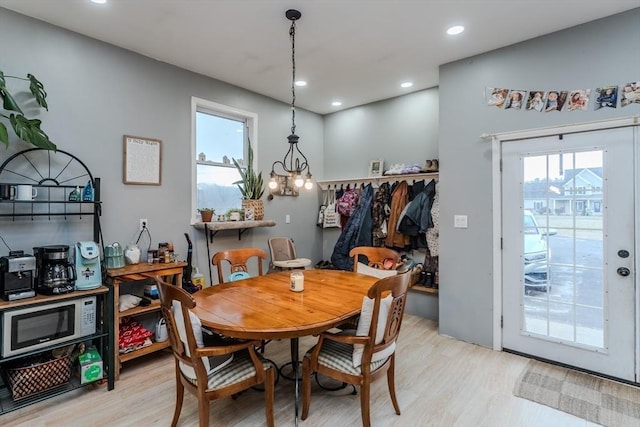 dining room with wood finished floors, a chandelier, and recessed lighting