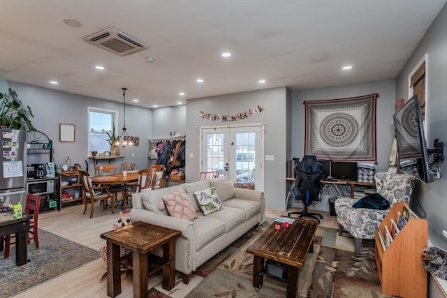 living room with wood finished floors, french doors, and recessed lighting