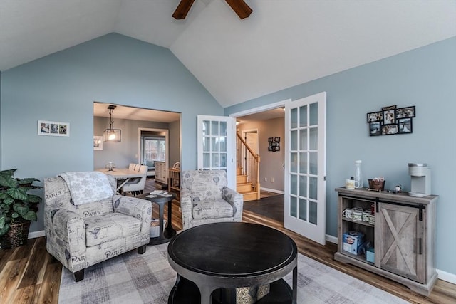 living area with french doors, wood finished floors, a ceiling fan, baseboards, and high vaulted ceiling