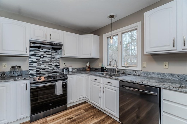 kitchen featuring stainless steel appliances, a sink, under cabinet range hood, and white cabinetry