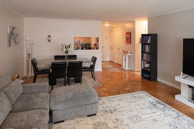 living room featuring crown molding and baseboards