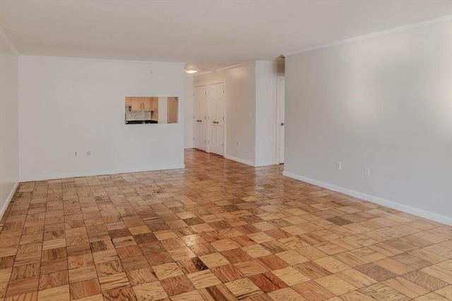 unfurnished room with baseboards and ornamental molding