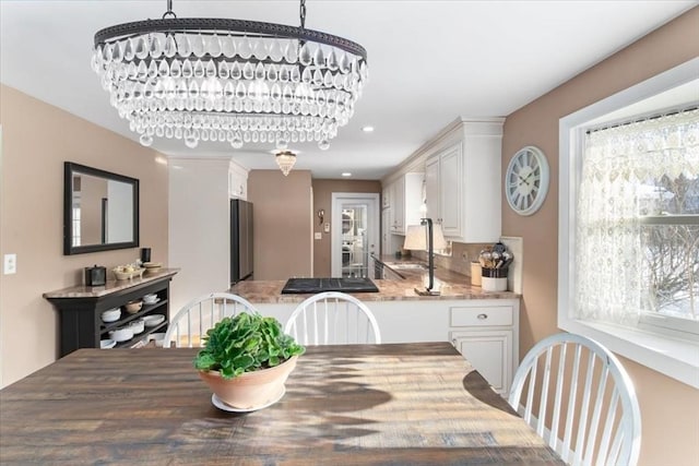 dining area featuring an inviting chandelier and sink