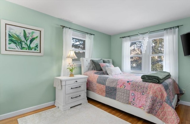 bedroom with hardwood / wood-style floors